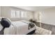 Bright bedroom with a bed, hardwood floors, and ensuite bathroom visible in the background at 10910 Touchstone Loop, Parker, CO 80134