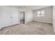 This bedroom features a neutral carpet, large window, and access to a walk-in closet at 10910 Touchstone Loop, Parker, CO 80134