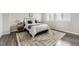 Comfortable bedroom featuring a large bed, stylish rug, and natural light from the windows at 10910 Touchstone Loop, Parker, CO 80134