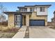 Modern two-story home featuring a contrasting color scheme and an attached two-car garage at 10910 Touchstone Loop, Parker, CO 80134