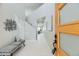 Bright foyer with white tile, modern bench, and a view through to the living area at 10910 Touchstone Loop, Parker, CO 80134