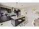 Modern kitchen featuring a large island with bar seating and stylish dark cabinetry at 10910 Touchstone Loop, Parker, CO 80134