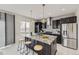 Modern kitchen with granite counters, stainless steel appliances, large island and stylish pendant lighting at 10910 Touchstone Loop, Parker, CO 80134