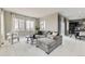 Open-concept living room with large windows, plush seating, and modern decor at 10910 Touchstone Loop, Parker, CO 80134
