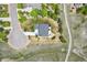 Aerial view of a home with a circular driveway, landscaped yard, and a beautiful lawn in a lush green neighborhood at 14958 Wistera Way, Broomfield, CO 80023