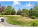 Lush green backyard featuring a stone gravel pathway with manicured landscaping and a beautiful lawn at 14958 Wistera Way, Broomfield, CO 80023