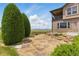 Beautiful backyard with stone patio, manicured landscaping, and scenic open space at 14958 Wistera Way, Broomfield, CO 80023