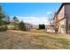 Expansive grassy backyard featuring mature trees and privacy fence at 14958 Wistera Way, Broomfield, CO 80023