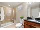 Bathroom featuring tiled shower, toilet, granite vanity, and built-in shelving at 14958 Wistera Way, Broomfield, CO 80023