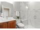 Modern bathroom featuring a glass shower with a bench, marble accents, and wood vanity at 14958 Wistera Way, Broomfield, CO 80023