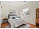 Bright bedroom with wood floors, large window, and neutral decor at 14958 Wistera Way, Broomfield, CO 80023