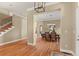 Elegant entryway showing staircase and formal dining room with hardwood flooring at 14958 Wistera Way, Broomfield, CO 80023