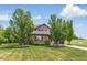 Attractive two-story home with stone accents, well-manicured lawn, and mature trees at 14958 Wistera Way, Broomfield, CO 80023
