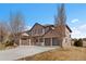 A picturesque home with a sprawling lawn, three-car garage, and elegant facade in a serene setting at 14958 Wistera Way, Broomfield, CO 80023