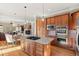 Gourmet kitchen featuring granite countertops, stainless steel appliances, and a spacious center island with gas cooktop at 14958 Wistera Way, Broomfield, CO 80023