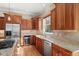 Chef's kitchen featuring stainless steel appliances, a gas cooktop, and granite countertops, ideal for entertaining at 14958 Wistera Way, Broomfield, CO 80023