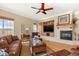 Cozy living room featuring a fireplace, large windows, and comfortable seating at 14958 Wistera Way, Broomfield, CO 80023