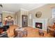 Cozy living room featuring hardwood floors, a fireplace, and ample seating for relaxation and entertainment at 14958 Wistera Way, Broomfield, CO 80023