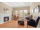 Bright living room with hardwood floors, a fireplace, and large windows that fill the space with natural light at 14958 Wistera Way, Broomfield, CO 80023