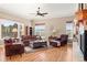 Sun-filled living room featuring hardwood floors, fireplace, and expansive windows with views of the property at 14958 Wistera Way, Broomfield, CO 80023