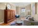 A living room with an area rug, comfortable seating, and neutral colors at 14958 Wistera Way, Broomfield, CO 80023