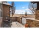 Charming outdoor patio featuring stone walls and an iron gate, offering a serene spot to enjoy the views at 14958 Wistera Way, Broomfield, CO 80023