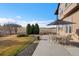 Back patio with stone pavers, outdoor table and chairs, and unobstructed views at 14958 Wistera Way, Broomfield, CO 80023