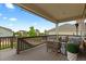 Relaxing outdoor deck area with comfortable seating, covered awning, and view of the yard at 23252 E Glidden Dr, Aurora, CO 80016