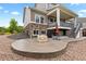 Spacious backyard featuring a stone patio, lower deck, and well-maintained landscaping at 23252 E Glidden Dr, Aurora, CO 80016