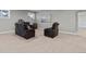 Finished basement area featuring a leather reclining sofa, accent barrel, neutral paint, and carpet flooring at 23252 E Glidden Dr, Aurora, CO 80016