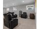 Finished basement featuring leather reclining sofas, 3 windows, and an accent barrel at 23252 E Glidden Dr, Aurora, CO 80016