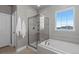 Beautiful bathroom featuring a glass-enclosed shower and a soaking tub at 23252 E Glidden Dr, Aurora, CO 80016