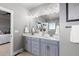 Modern bathroom with double vanity, white quartz countertop, and a large mirror at 23252 E Glidden Dr, Aurora, CO 80016
