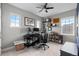 Bedroom featuring a ceiling fan, 3 windows, decor shelves, and a desk for home office use at 23252 E Glidden Dr, Aurora, CO 80016