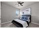 Cozy bedroom featuring a modern ceiling fan, neutral paint, plush carpet, and a stylishly made bed at 23252 E Glidden Dr, Aurora, CO 80016