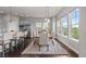 Dining area with large windows, pendant lighting, and hardwood floors attached to the modern kitchen at 23252 E Glidden Dr, Aurora, CO 80016