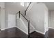 Bright entryway with dark hardwood floors and carpeted stairs at 23252 E Glidden Dr, Aurora, CO 80016