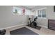 Home exercise room with Peloton bike, motivational decor, and natural light from bright windows at 23252 E Glidden Dr, Aurora, CO 80016