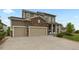 Beautiful two-story home with stone accents, a manicured front yard, and a two-car garage at 23252 E Glidden Dr, Aurora, CO 80016