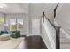 Inviting foyer with dark wood floors, a staircase, and a view into the adjacent living room at 23252 E Glidden Dr, Aurora, CO 80016