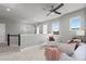Inviting living room with plush seating, a ceiling fan, lots of natural light and a neutral color palette at 23252 E Glidden Dr, Aurora, CO 80016