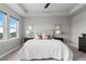 Main bedroom with plush carpet, tray ceiling, and large windows at 23252 E Glidden Dr, Aurora, CO 80016