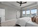 Well-lit main bedroom featuring plush carpet and three large windows at 23252 E Glidden Dr, Aurora, CO 80016