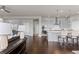 Open floorplan concept with modern kitchen, living room, dining area and hardwood floors at 23252 E Glidden Dr, Aurora, CO 80016