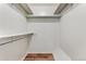 Walk-in closet with shelving, bar for hanging, and vinyl plank floors at 6650 E Arizona Ave # 203, Denver, CO 80224