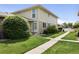 Exterior of condo with well-maintained front lawn and a paved walkway at 6650 E Arizona Ave # 203, Denver, CO 80224