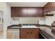 Well-equipped kitchen featuring dark cabinets, gray counters, and a pass-through window at 6650 E Arizona Ave # 203, Denver, CO 80224