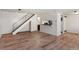 Open-concept living room, hardwood floors, staircase, and breakfast bar at 6650 E Arizona Ave # 203, Denver, CO 80224