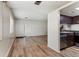 Open-concept living room, hardwood floors, stainless steel dishwasher, and stove at 6650 E Arizona Ave # 203, Denver, CO 80224