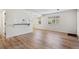 Open-concept living room, hardwood floors, breakfast bar, and bright windows at 6650 E Arizona Ave # 203, Denver, CO 80224